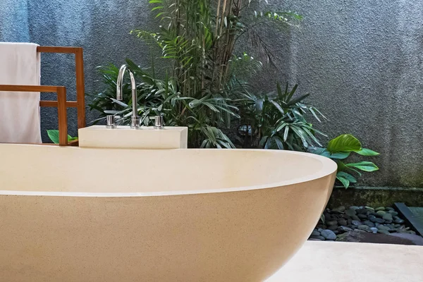 Stone bathtub in modern villa with open space bathroom.