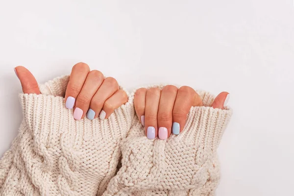 Womans hands with proffesional manicure in pastel colors — Stock Photo, Image