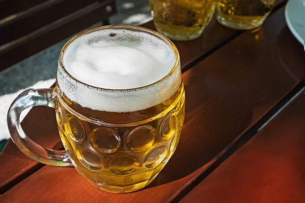 Traditional beer mug with light lager beer close-up