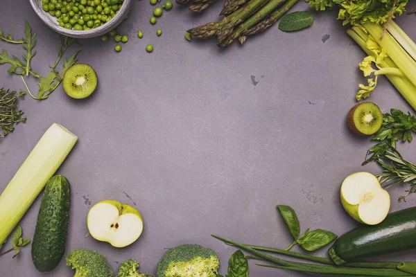 Fresh organic green vegetables and spices on grey stone table. — Stock Photo, Image