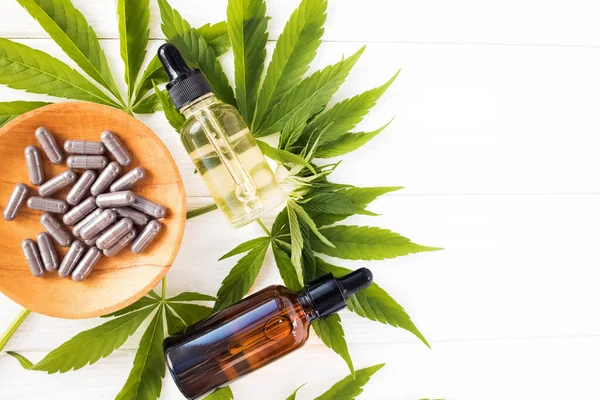Cannabis CBD oil and hemp products on white table — Stock Photo, Image