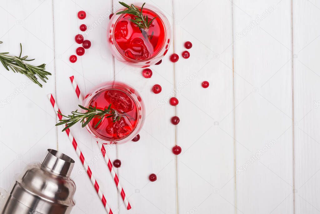 Cranberry cocktail with rosemary on white table