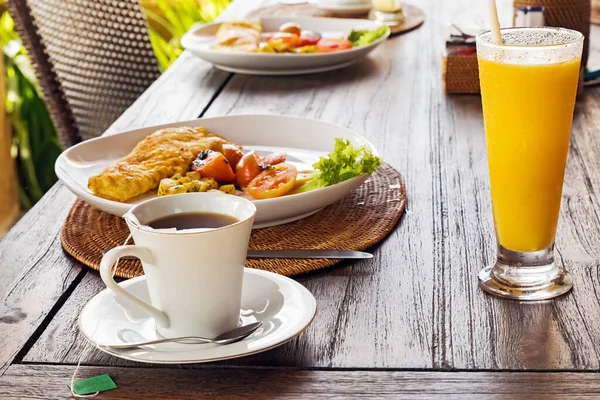 Colazione sana con omellete, insalata, succo di frutta e caffè sul tavolo di legno — Foto Stock