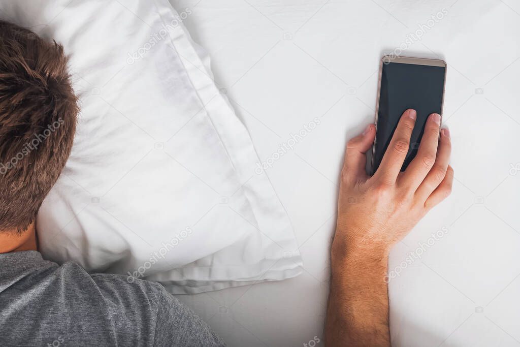 Close-up of man holding hand on phone at the morning