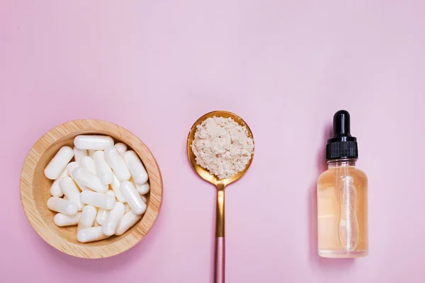 Kollagén termékek szérum, por és tabletták rózsaszín alapon — Stock Fotó