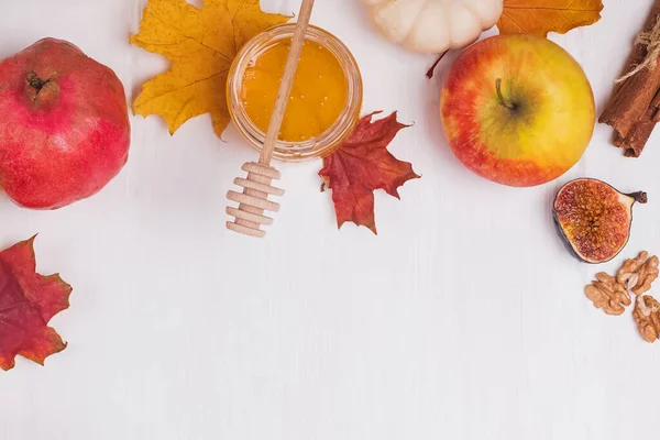 Podzimní ovoce a suché javorové listy na bílém stole — Stock fotografie