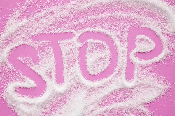 Word STOP made of sugar on color background. — Stock Photo, Image