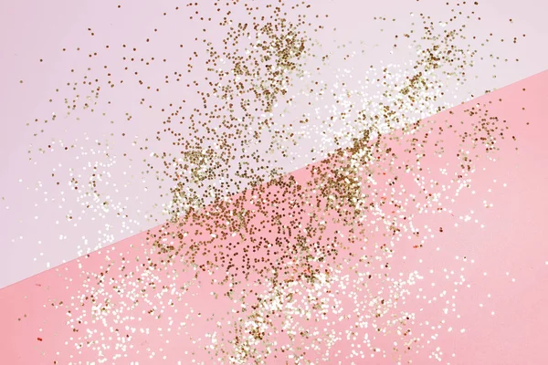 Golden stars glitter on pink background. Festive holiday pastel backdrop. — Stock Photo, Image