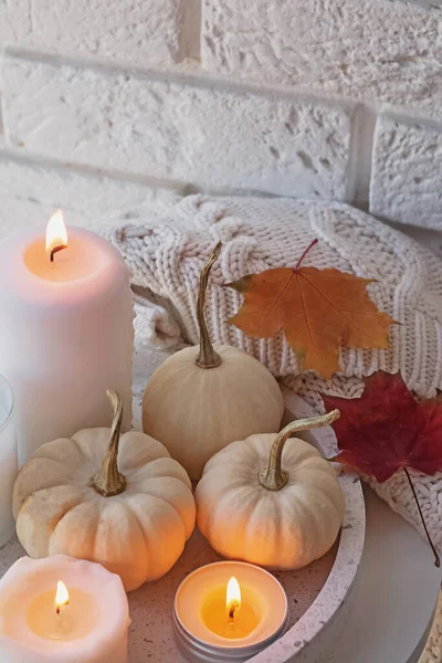 Autumn decor with white pumpkins and burning candles — Stock Photo, Image