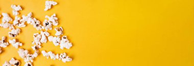 Sarı arka planda patlamış mısır, üst manzara. Metin için yeri olan pankart biçimi