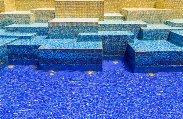 Texture blue mosaic tile background, Water wave swimming pool with reflecting