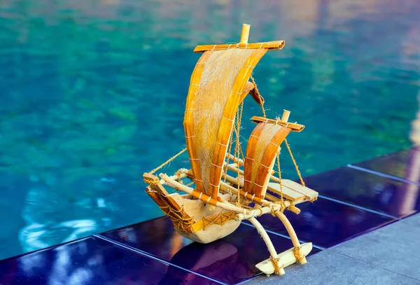 Popular landmark traditional souvenir sail fishing boat from Sri Lanka Bluewater Sailing pool beach.