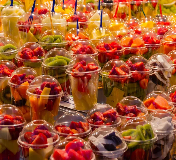 Tropical fresh fruits refreshing Set juice salad in the glasses cups, jars with fruit mix.