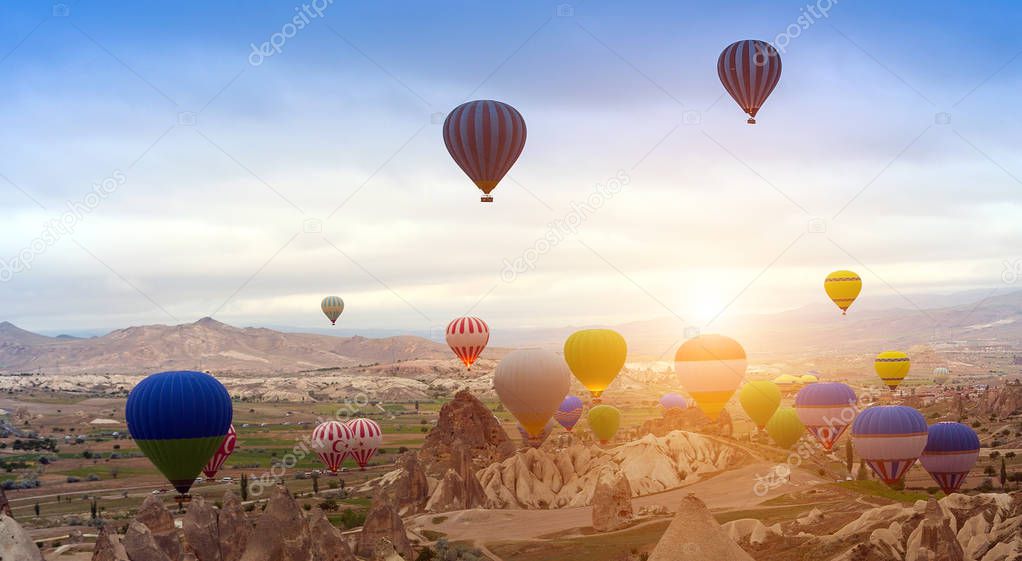Turkey Hot air balloon Tour in sunrise mountain Cappadocia. Panoramic views of the fairy chimneys and rock formations Goreme Open Air Museum