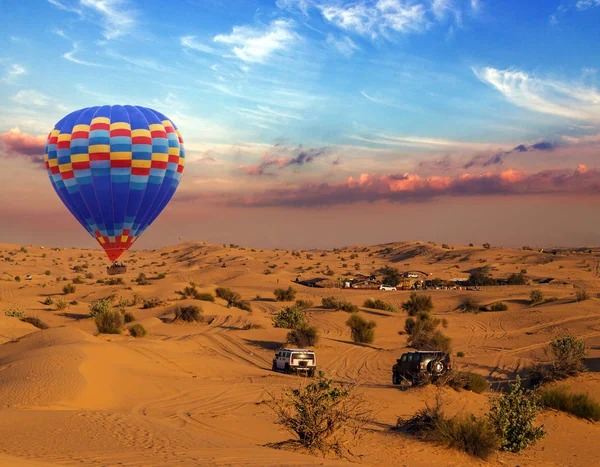 Hot air balloons landing rally off-road car sand dunes in the de