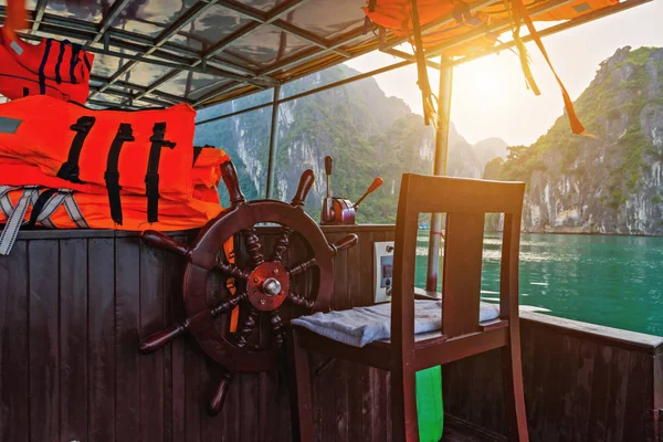 Orange life jacket Halong Bay wooden wheel Ha Long Bay.