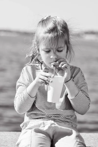 海の横にココアを飲んで甘い小さな女の子 — ストック写真