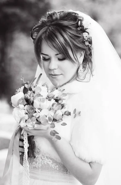 redhead pretty young bride with flowers in hands