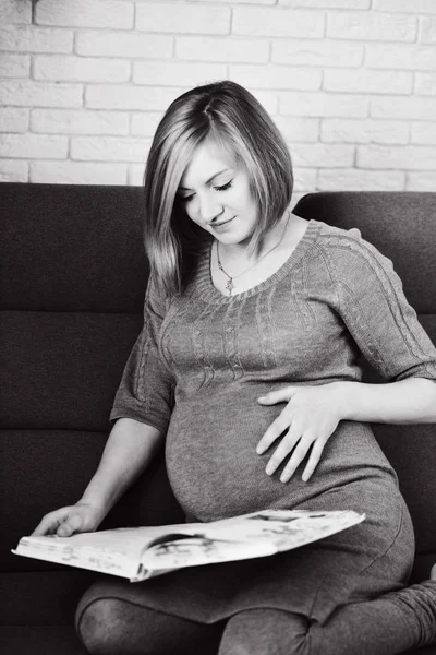 漂亮的孕妇在家看书 — 图库照片