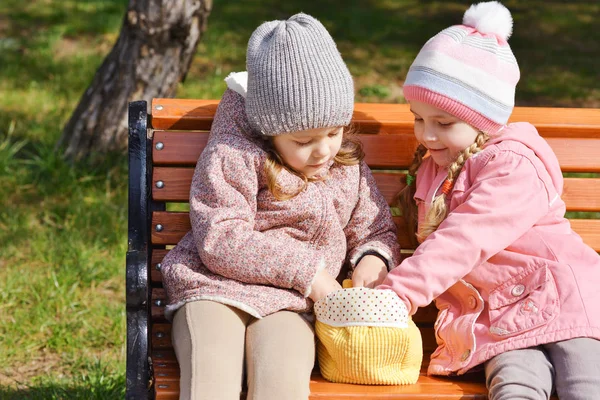 Iki Kız Oyuncakları Bankta Oynarken — Stok fotoğraf