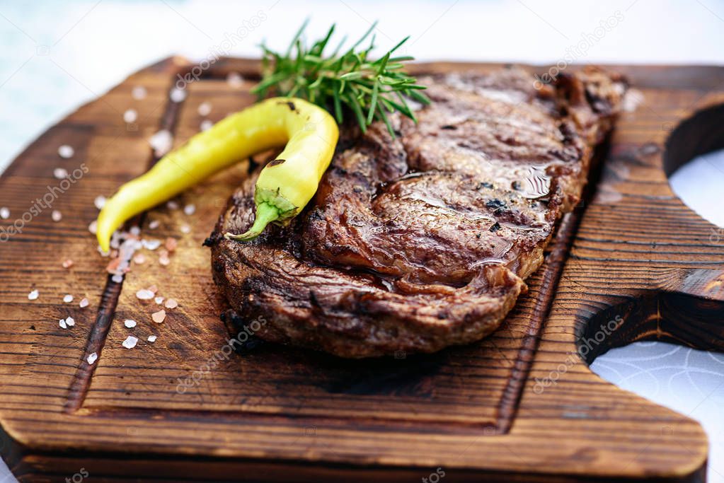 Barbecue rib eye steak or rump steak  on the wooden plate