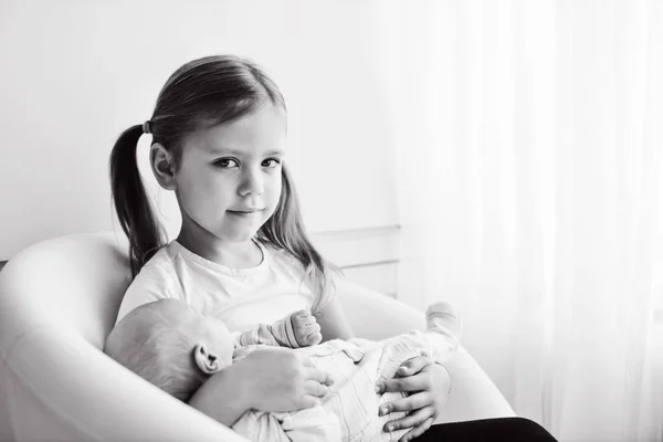 Sister Holding Her Newborn Brother Home — Stock Photo, Image