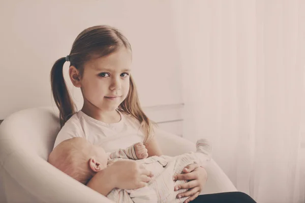 Sister Holding Her Newborn Brother Home — Stock Photo, Image