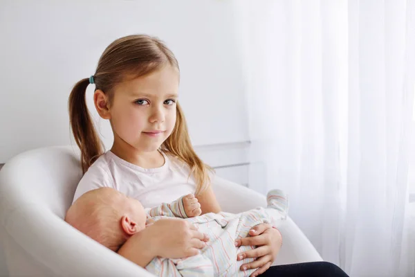 Sister Holding Her Newborn Brother Home — Stock Photo, Image