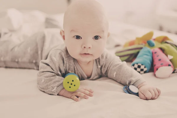 Baby lying on the bed — Stock Photo, Image