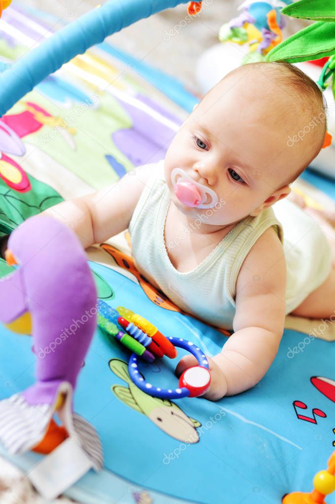  baby on the toy rug