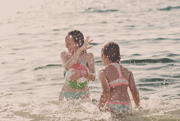 Girls playing in sea — Stock Photo, Image