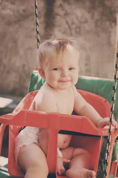 Baby in the  swing — Stock Photo, Image