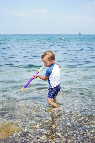 Kleiner Junge spielt im Meer — Stockfoto