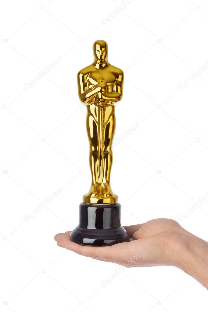 Hand with Award of Oscar ceremony isolated on white background