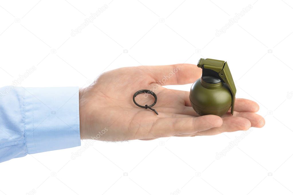 Hand pulls a check from a grenade isolated on white background