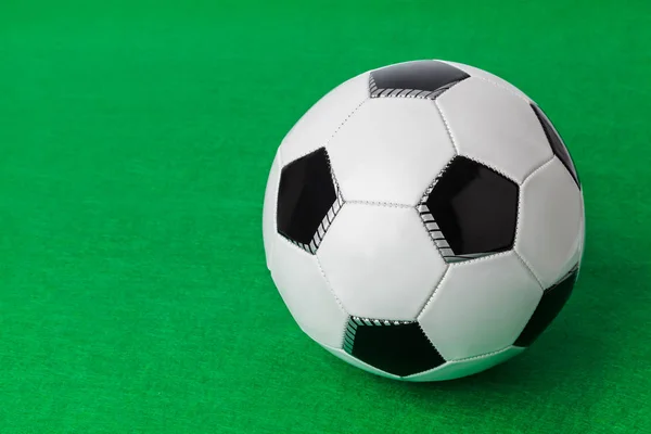 Soccer ball on football field - sport background