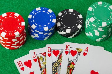 Kumarhane fişleri ve iskambil kağıtları yeşil masada - kumar geçmişi