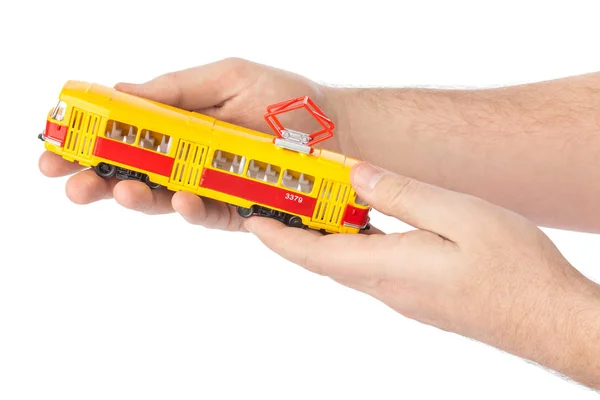 Hands with toy tram — Stock Photo, Image