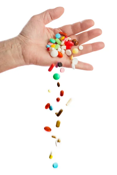 Hand och fallande piller — Stockfoto