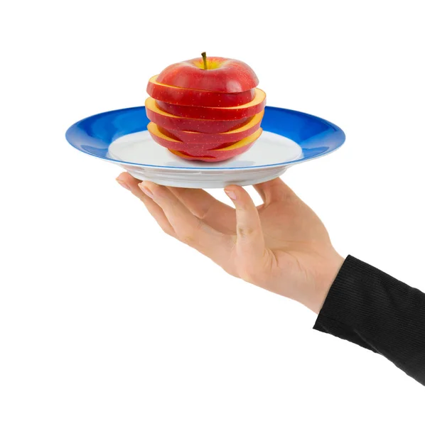 Mão com prato e maçã picada — Fotografia de Stock