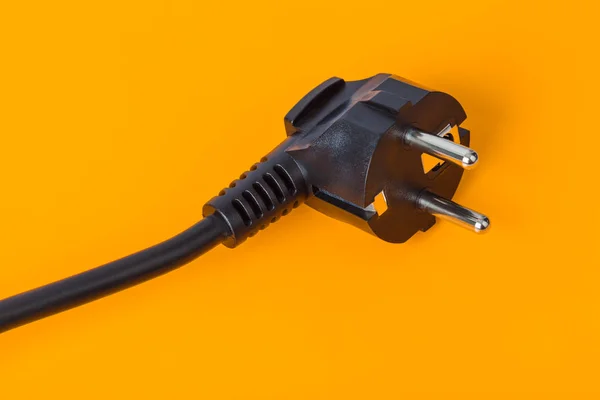 Electrical plug on orange background