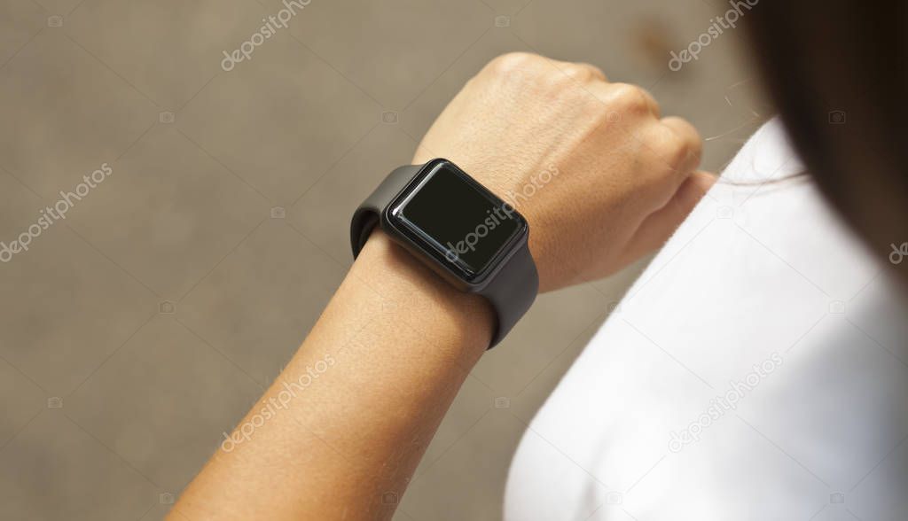 Woman is looking on her smart watches on her hand