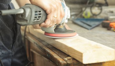 Adam tahta paneli öğütüyor. 