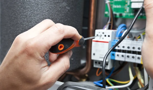De man is het installeren van de elektrische apparatuur in het huis — Stockfoto