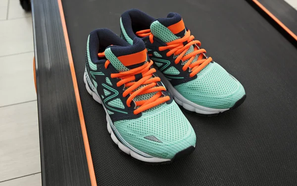 The pair of new woman  sport shoes on the black treadmill — Stock Photo, Image