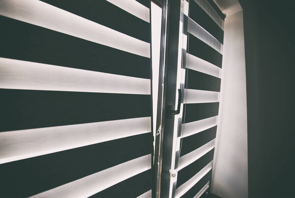 Roller shutters on the plastic brown window in the living room