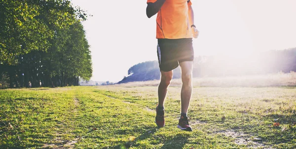 One young man is jogging cross-country through the pathway in th — Stock Photo, Image