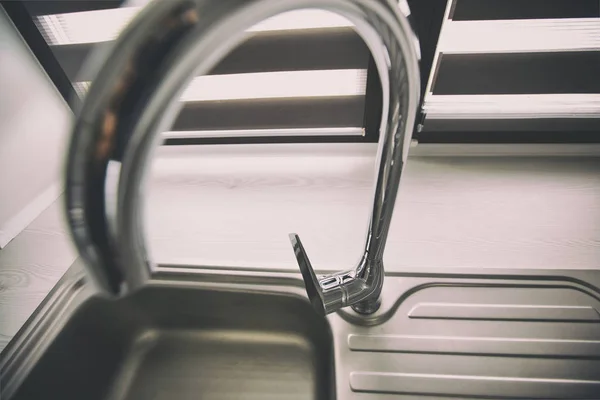 Metal faucet in the modern gray kitchen — Stock Photo, Image