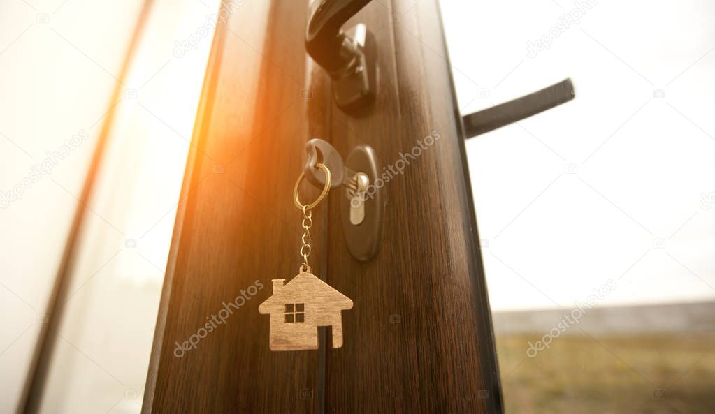 A trinket in shape of house on the key in the keyhole