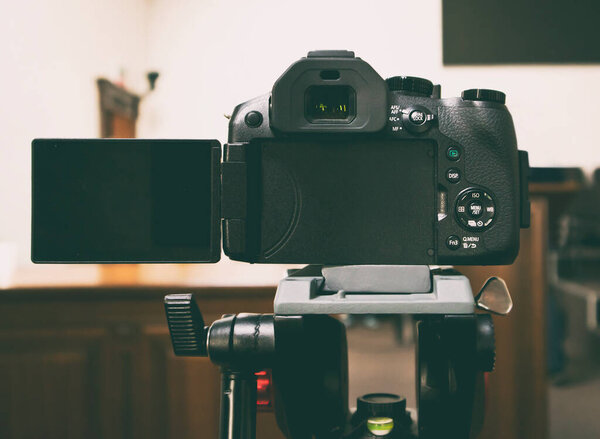 The modern mirrorless camera on the tripod